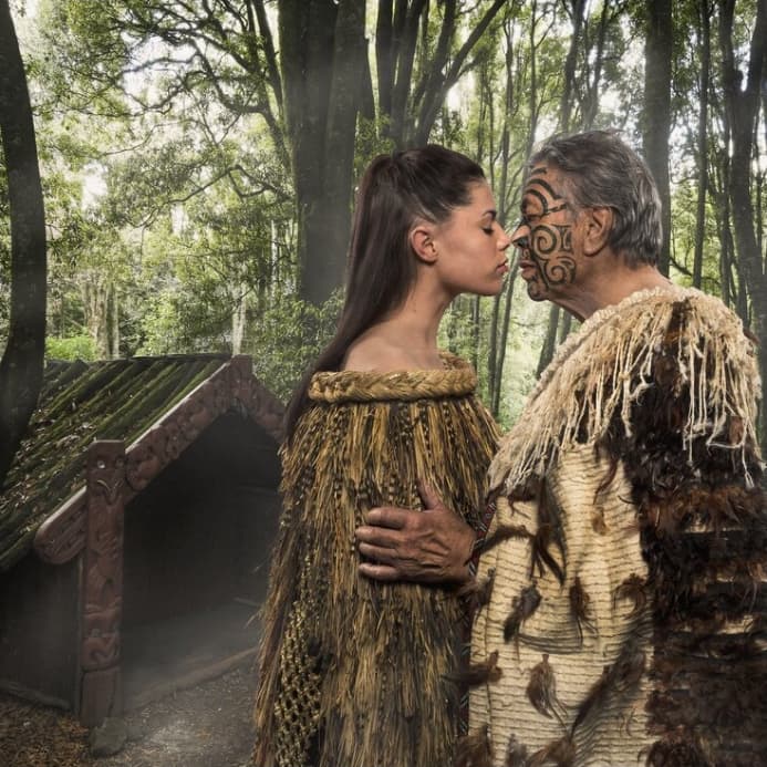 Dreamaroo Luxury, Tamaki Maori Village Man and Woman Touching Heads With Eyes Closed, Traditional Face Paint & Clothing Image