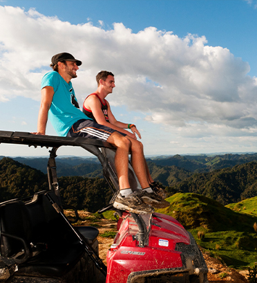 Dreamaroo Luxury, Adventure Wilderness New Zealand, Two Men Sitting On Top of Jeep Wrangler, View of Green Nature Hills Image