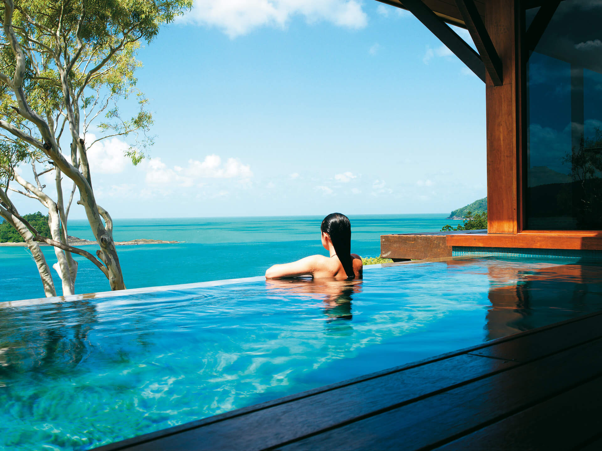 Dreamaroo Luxury, Hamilton Island, Woman Leaning On Poolside Edge, View of Ocean Image